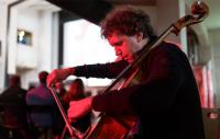 A photo of a man playing a cello