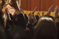 A theatre audience clapping