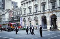 The Strand Street In Central London, England, United Kingdom, August 17, 2024,Street: Strand; District: Covent Garden; Borough: City of Westminster; County: Greater London. fire trucks are parked at Somerset House public square, in daytime late afternoon in summer time, there are several Metropolitan police officers and firemen. Police officers and firemen and fire trucks.