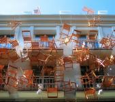 Photo of chairs hanging in front of building