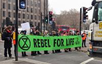 Protesters stopping traffic holding a 'Rebel for life' banner