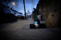 Man sticking his head up from a sewer