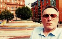 photo of Andrew Miller beside Jeremy Miller's Peterloo Memorial in Manchester