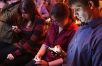 Photo of a group of people looking at their phones