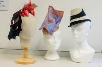 Three hats on display on hat mannequins