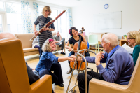 Musicians playing to patients in a care settting