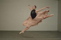 A female dancer leaping through the air