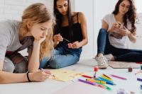 Young women are taking part in an art session together