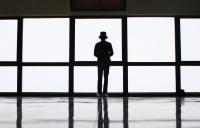 Photo of man standing by window