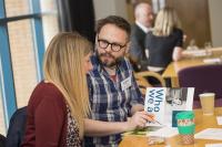 A man and woman having a discussion at a table