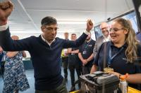 Prime Minister Rishi Sunak cheering at a training academy