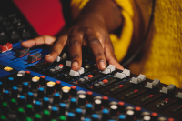 A sound engineer adjusts a fader