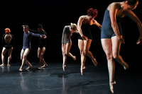 Dancers from National Dance Company Wales on a dark stage