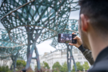 Man taking a picture of art installation