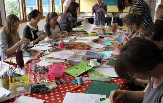 A group of people around a table doing craftwork