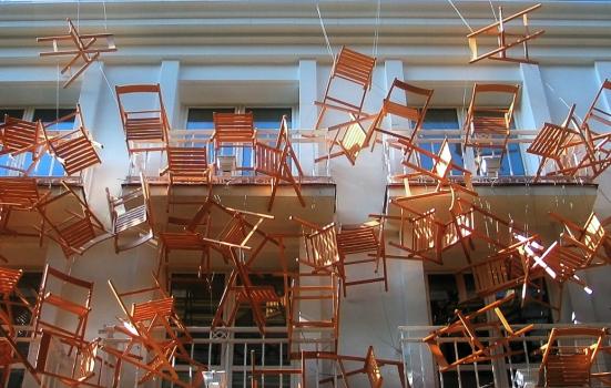 Photo of chairs hanging in front of building