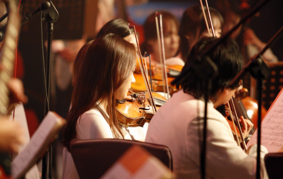 a woman plays in an orchestra