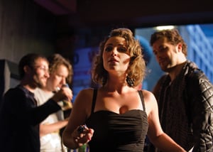 Woman wearing a black cocktail dress in dramatic pose