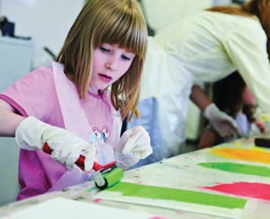 Girl painting with roller