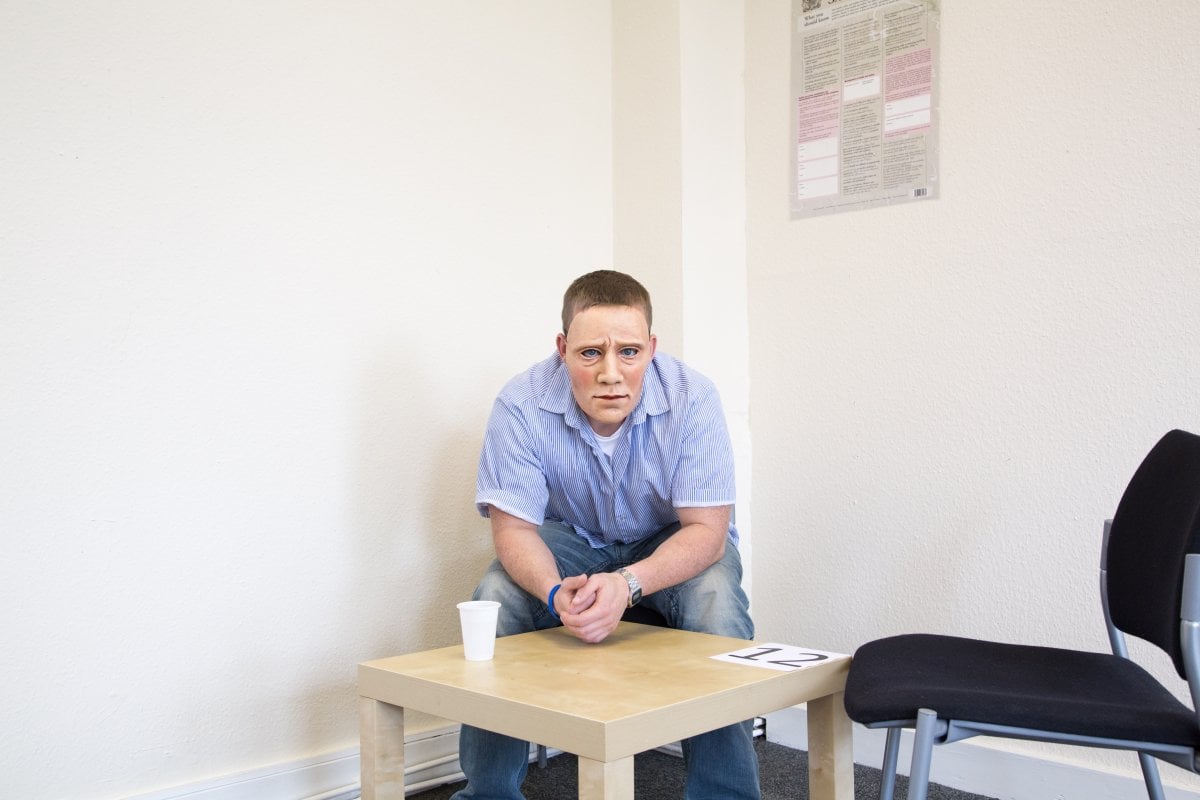 Individual sits with a mask - theatre in prisons