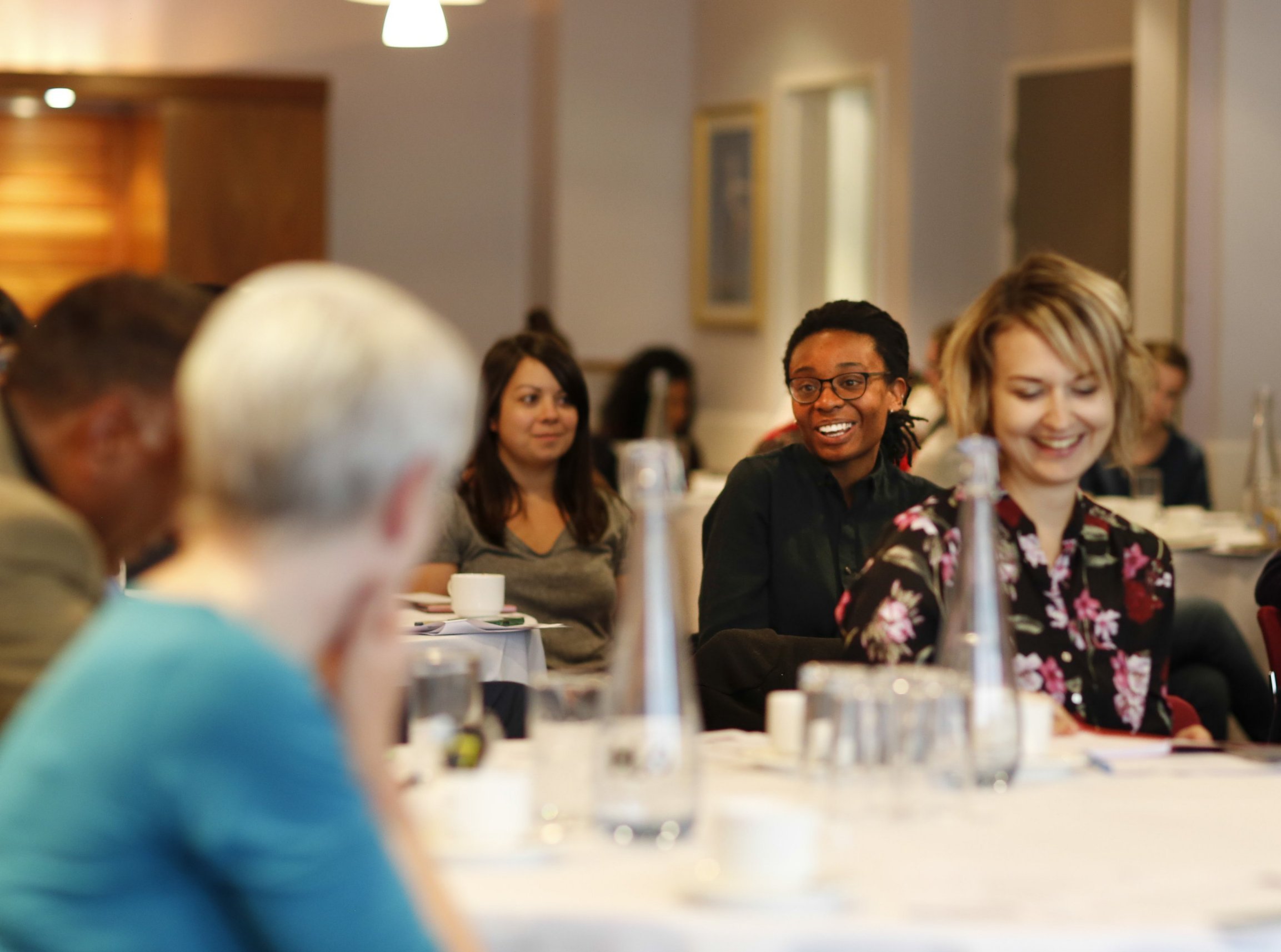 Photo of women smiling at a dinner