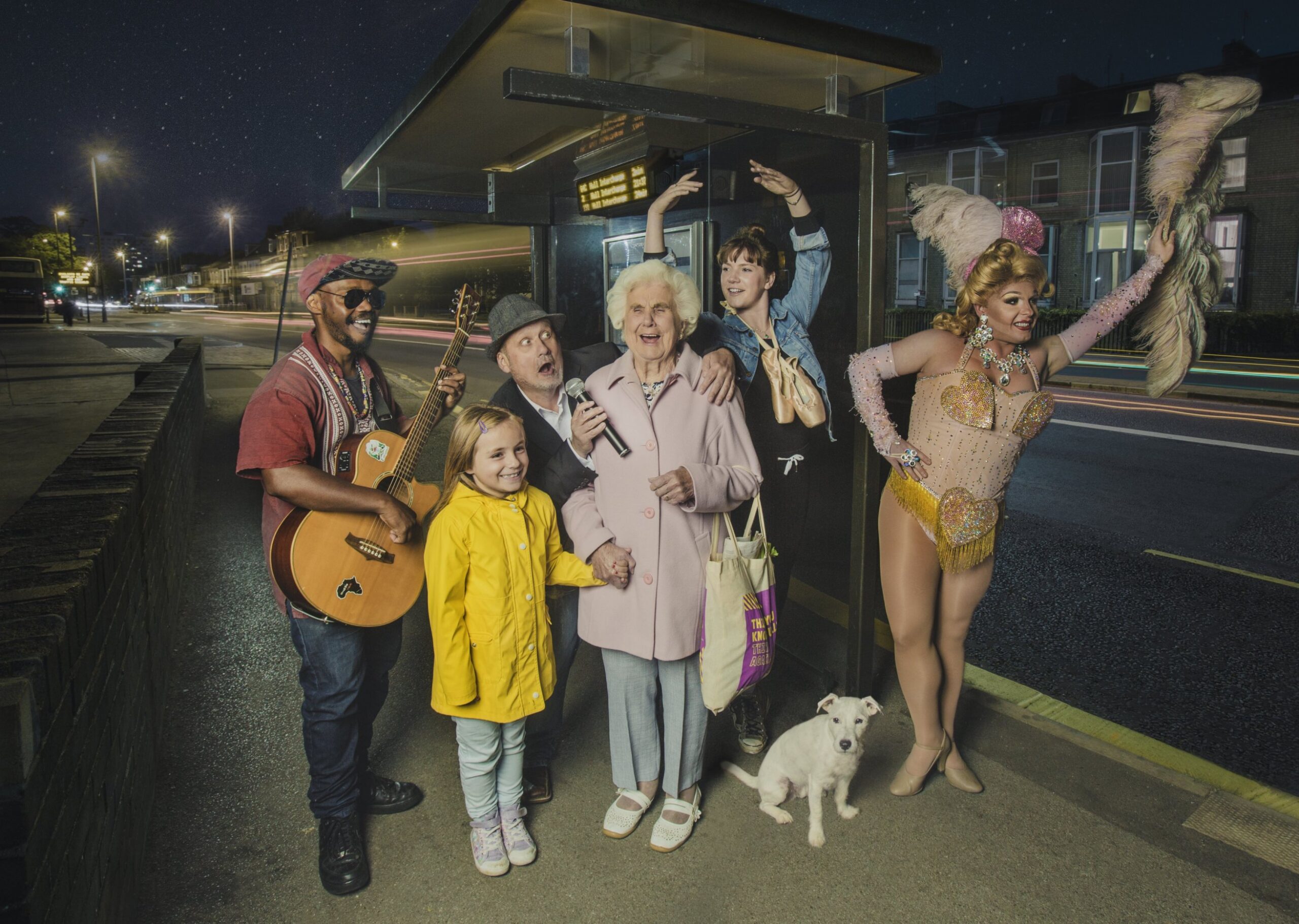 Photo of performers and family at a bus stop