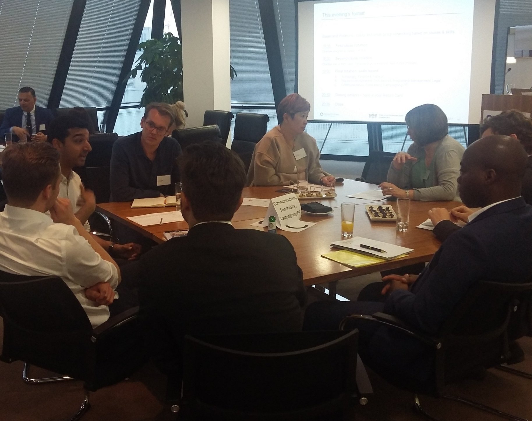 Photo of people sitting round a table at a workshop