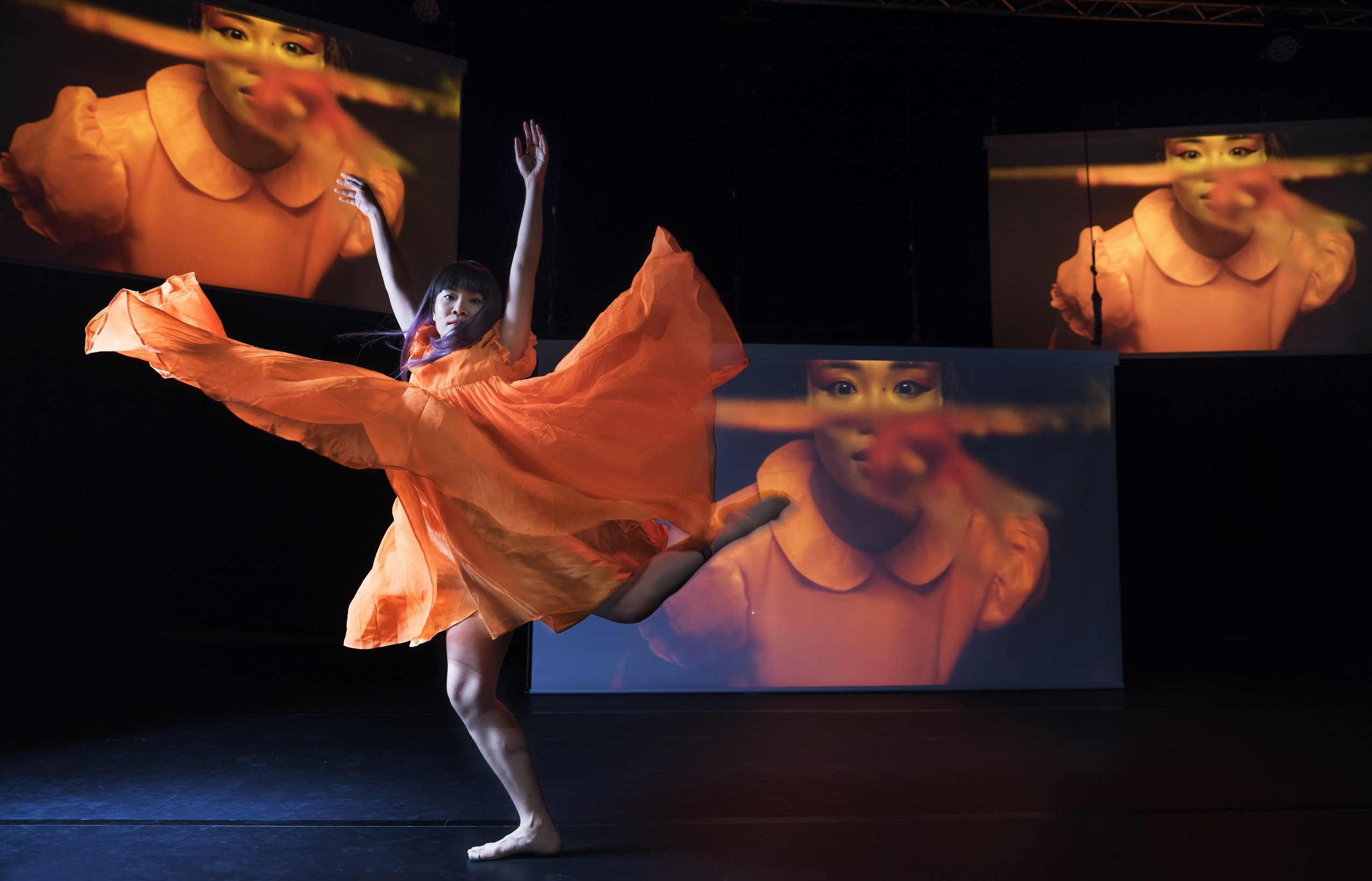 Photo of dancer with screens in background