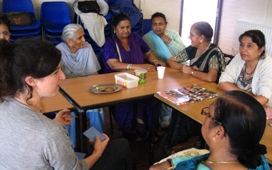 photo of women sitting around table