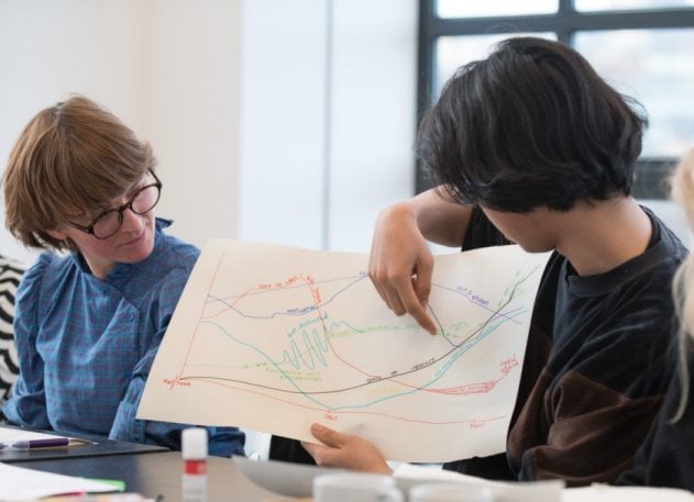 Photo of two women looking at a diagram