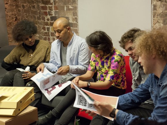 Photo of young people looking at papers