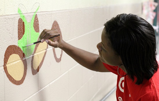 A photo of a woman painting