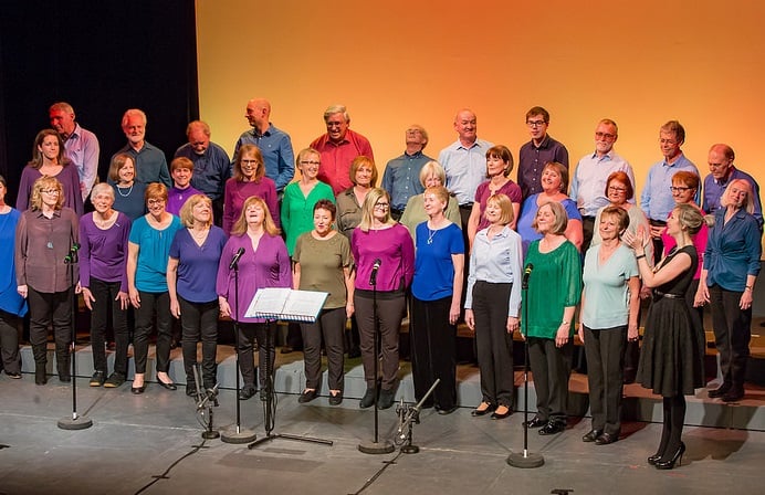 A choir of people wearing colourful clothes