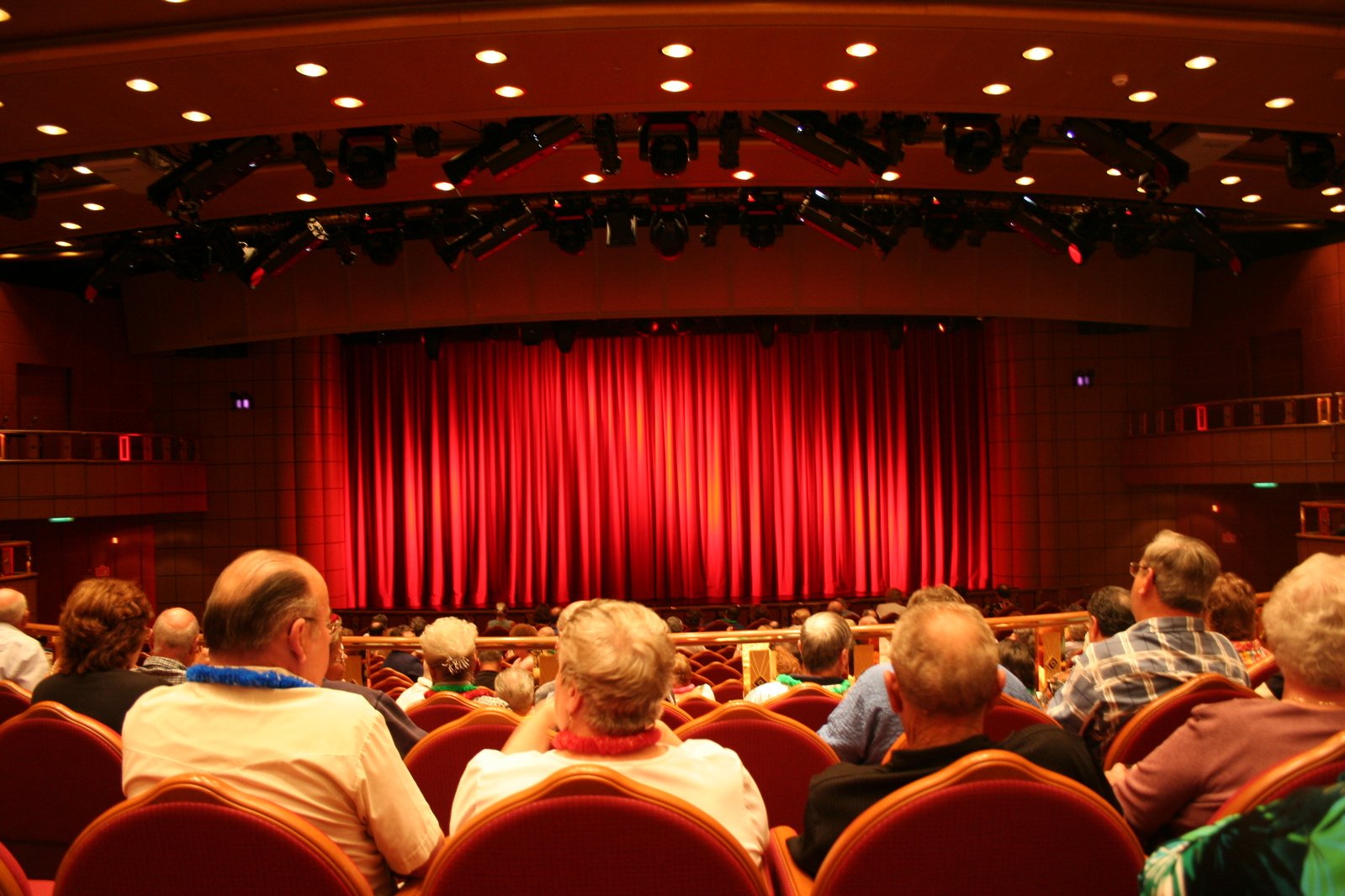 An audience including older people in a theatre auditorium