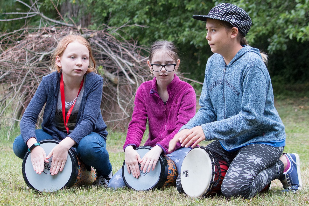 Three children playing drums