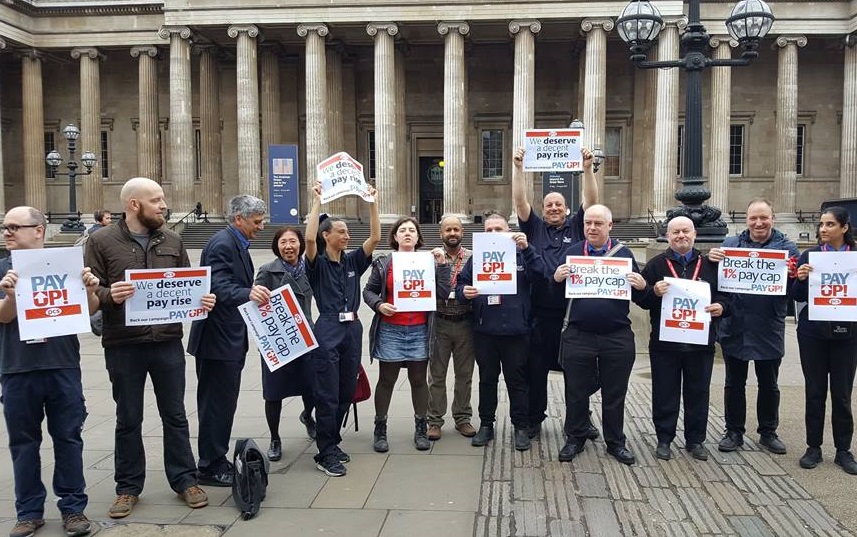 People standing outside the British Museum holding placards