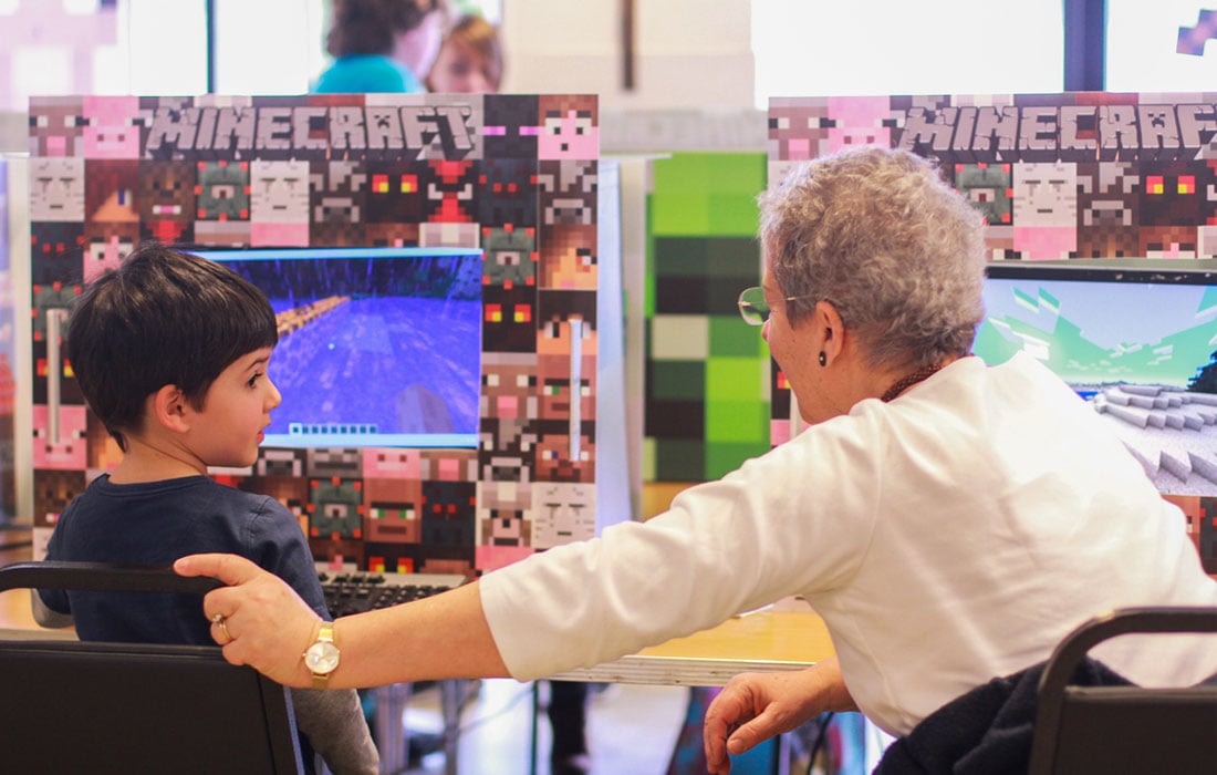 Photo of woman and child playing Minecraft