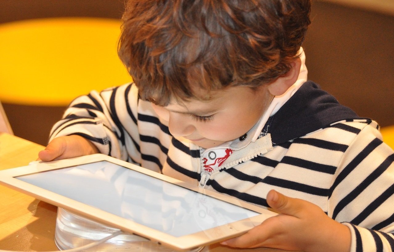 A photo of a boy holding a tablet