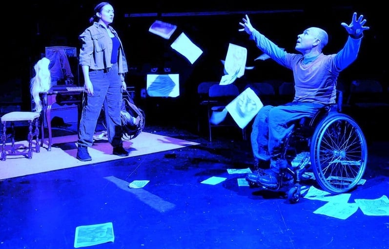 A photo of a performance including an actor in a wheelchair