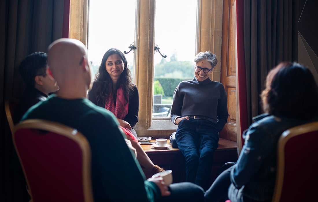 people sitting chatting in a group in a darkened room