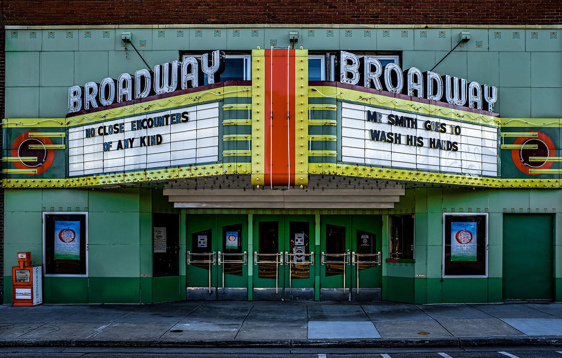 Front of a cinema in Mount Pleasant Michigan with banners 'No close encounters of any kind' and 'Mr Smith goes to wash his hands'