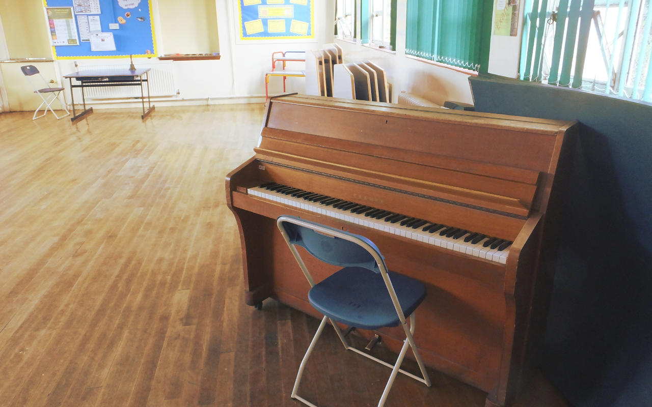 A piano in a school hall