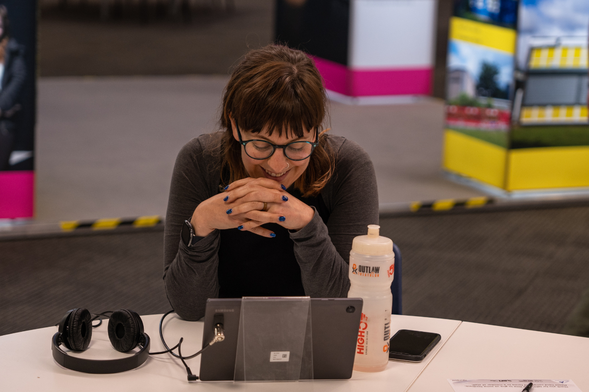 Woman sitting at a desk in front of a laptop