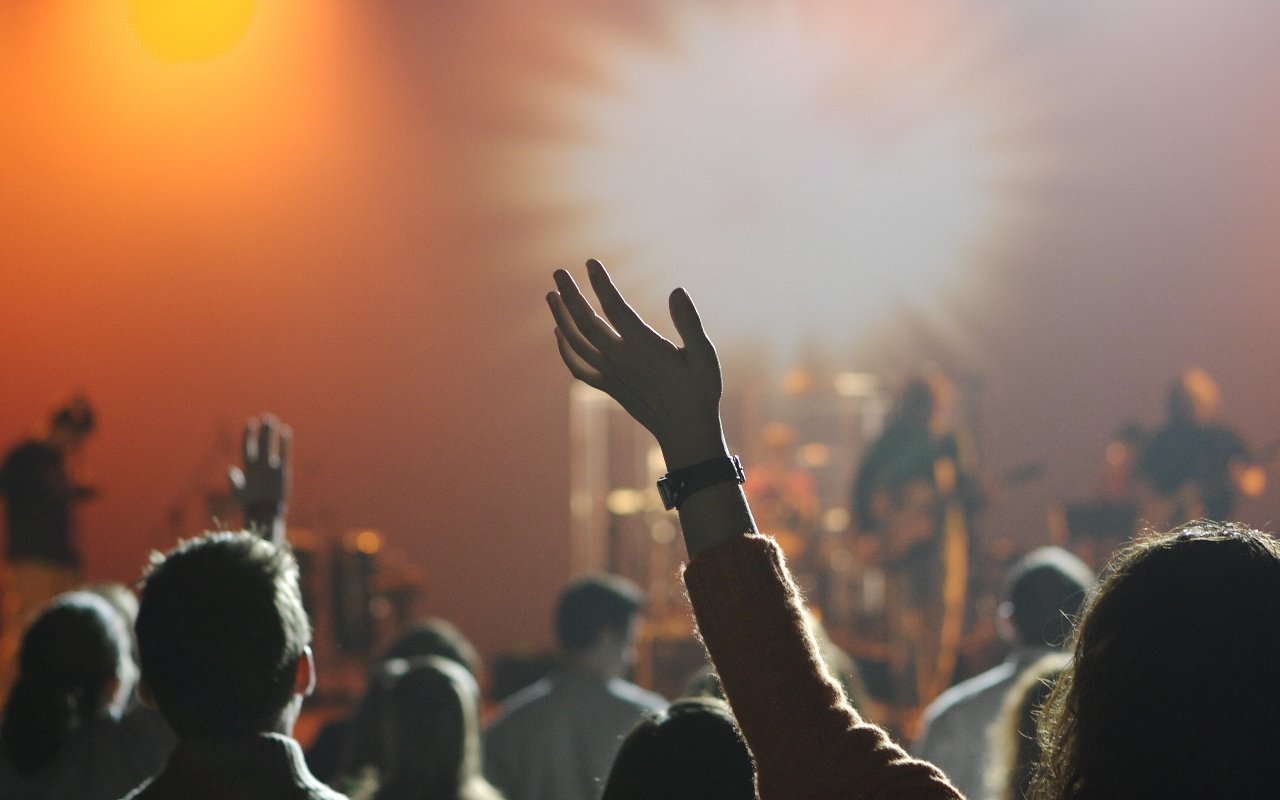 A crowd watch a musician perform on stage