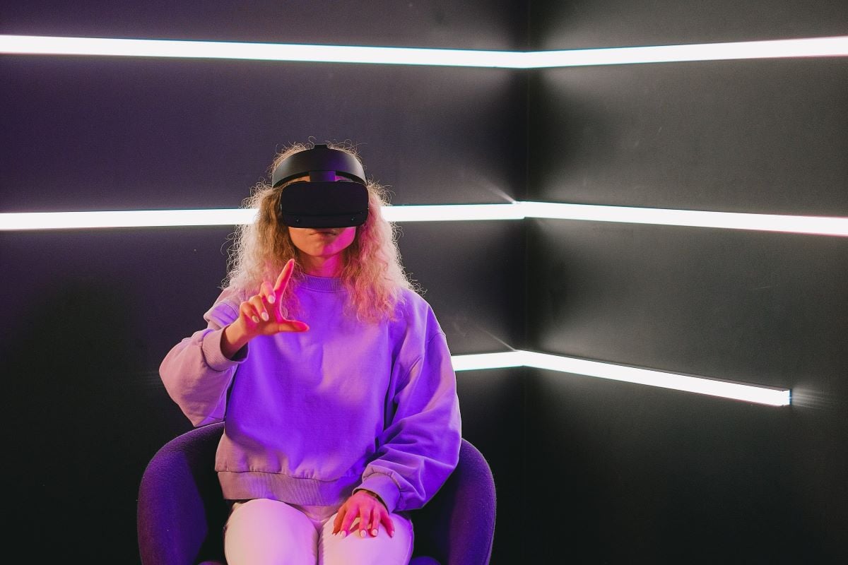 A seated woman using a VR headset