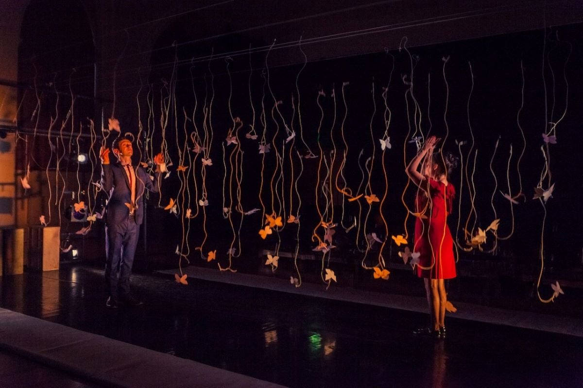 Picture from a show called The Life & Loves of a Nobody, which toured in 2014, in which performers pull on some of the strings suspending white paper butterflies and they all bounce off and fall to the ground.