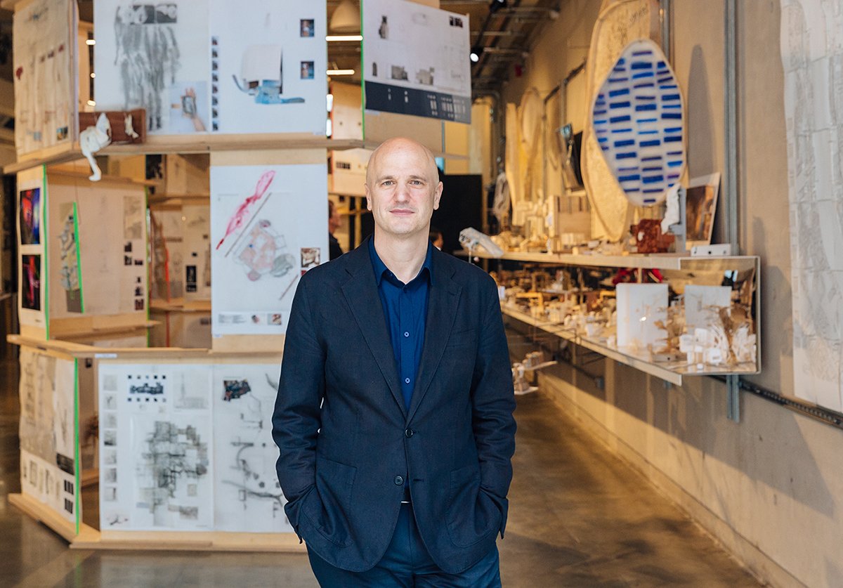 Professor Christoph Lindner. He is photographed in a studio wearing a navy blazer and suit.