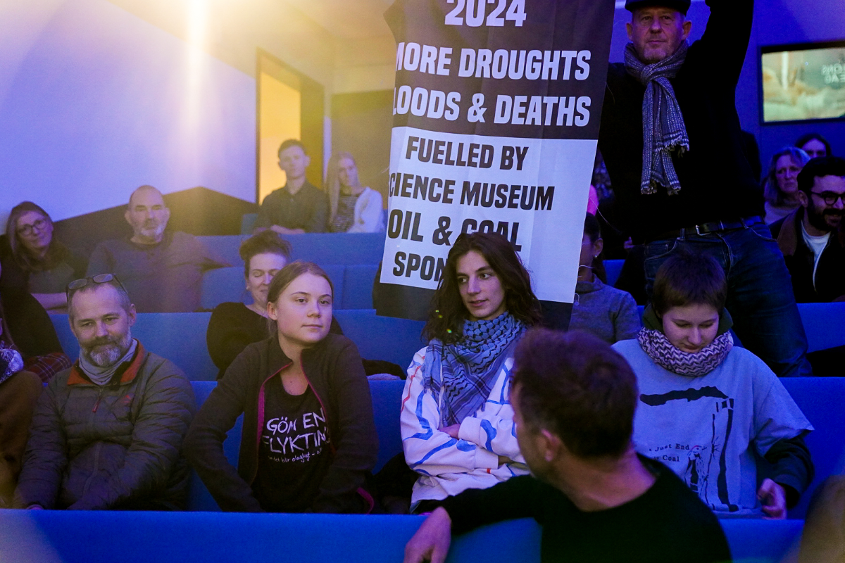 Protesters sitting in on a panel debate organised by the Science Museum