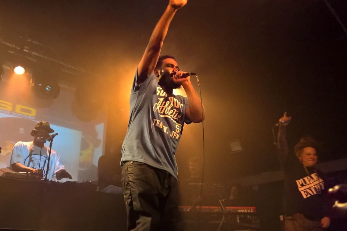 A man performing on stage at a small music venue