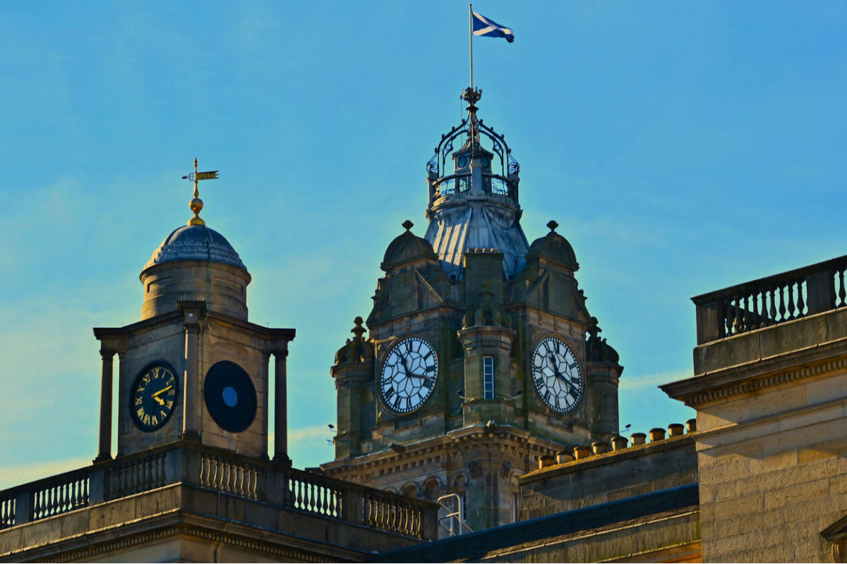 Clock tower in Edinburgh with Scottish flag